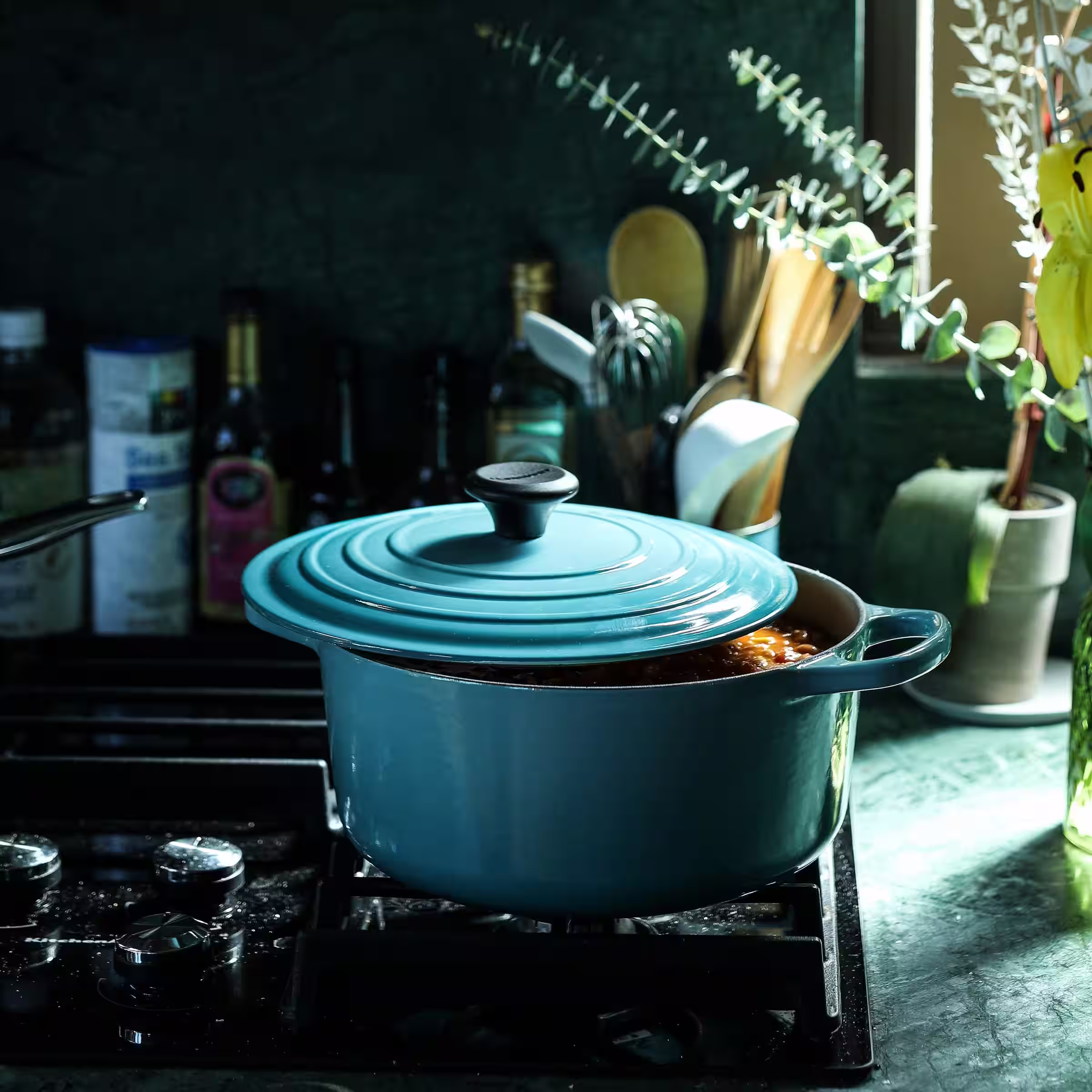 A dutch oven sitting on the stove with your delicious beef stew simmering inside.